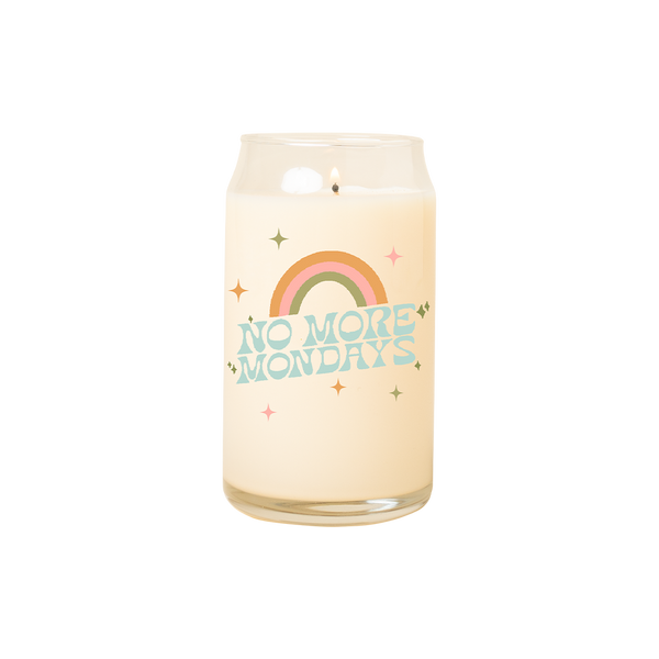 A 16 oz. candle with "No more mondays" printed on the front with a rainbow arch over the phrase and twinkle stars surrounding the phrase.