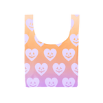 ombre orange to light purple compact reusable tote bag with pumpkin hearts on all sides 