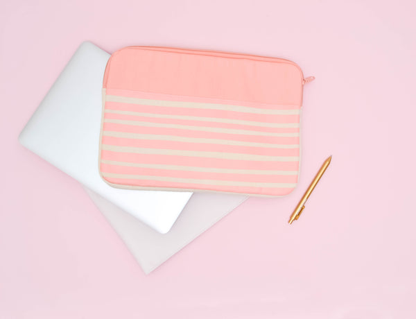 Peach Stripes Canvas Laptop Sleeve is a cute laptop sleeve in 13 inch size on top of a macbook