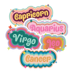 Multicolored astrology stickers with sparkles scattered around the zodiac sign name. Stickers displayed are Capricorn, Aquarius, Cancer, Leo, and Virgo.