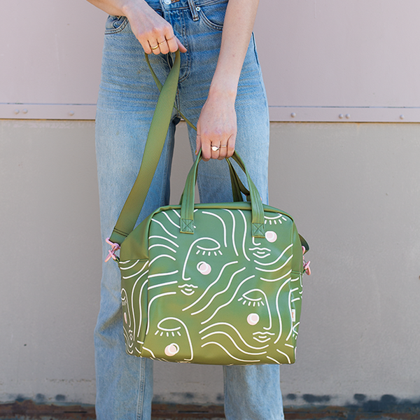 A lady holding the Zen Ladies skate bag.