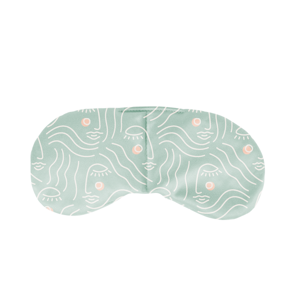 Mint colored weighted pillow with a white outline silhouette drawing of a woman's face with blush colored cheeks pattern