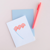 White greeting card with a blue and coral pennant with text 