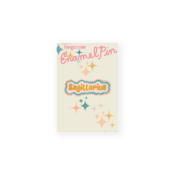 A Sagittarius Enamel Pin with burnt orange lettering and a light pink background. Perimeter lining of pin is blush pink, teal, and mint.