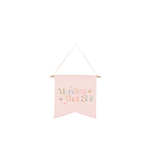 Light pink colored hanging wallflower with "Manifest That Shit" printed in multiple colors