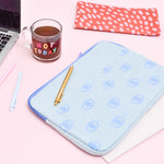 Eyeballs Canvas Laptop Sleeve is a cute laptop sleeve in light denim with eyeballs pattern in 13 inch size next to a macbook and jotters