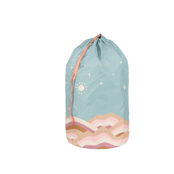 Laundry bag with hills in browns and pinks with a blue sky with stars and a sun
