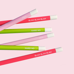 Bright pink, light pink and lime green pencils laying on a light pink background.