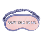 A sleep mask with periwinkle outline and strap that says don't talk to me 