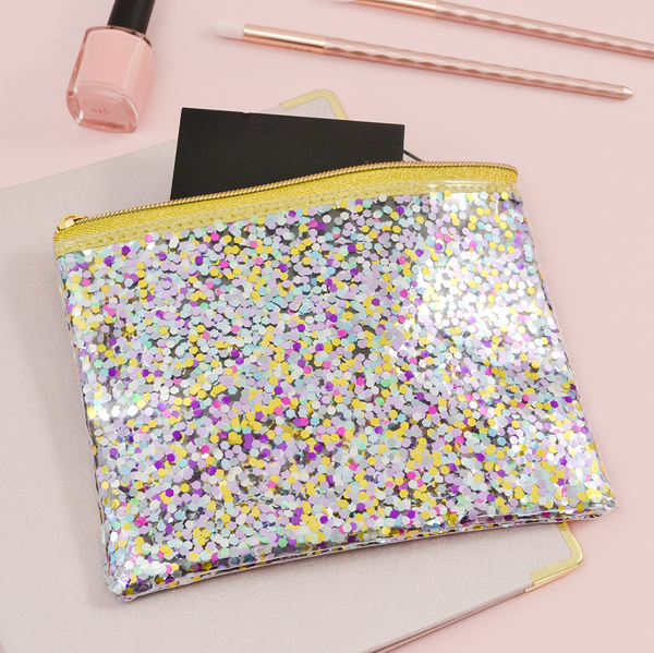Small zippered pouch in clear vinyl with glitter confetti and a gold zipper.
