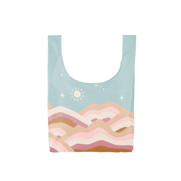 Multicolored, pastel, medium-sized tote bag with abstract hills and a sun in a starry blue-toned sky.