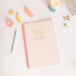 Weekdays planner with Powder Blue jotter pen, teal and pink besties for the resties jar candle, yellow and peach pastel highlighter.
