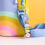 Gold plated key charm with "CIAO" on it in baby blue, yellow, green, and pink lettering. It is attached to a water bottle slinger.