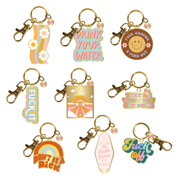 An assortment of 9 Talking Out Of Turn enamel key charms.