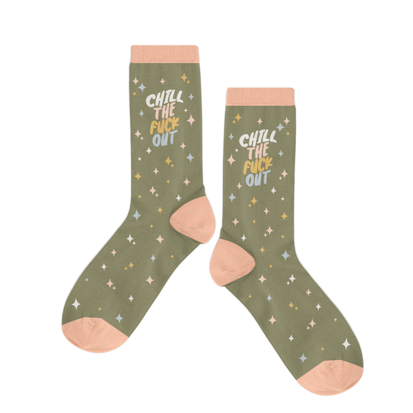 Olive green socks that say "CHILL THE FUCK OUT" with pastel rainbow stars and pale trimmings