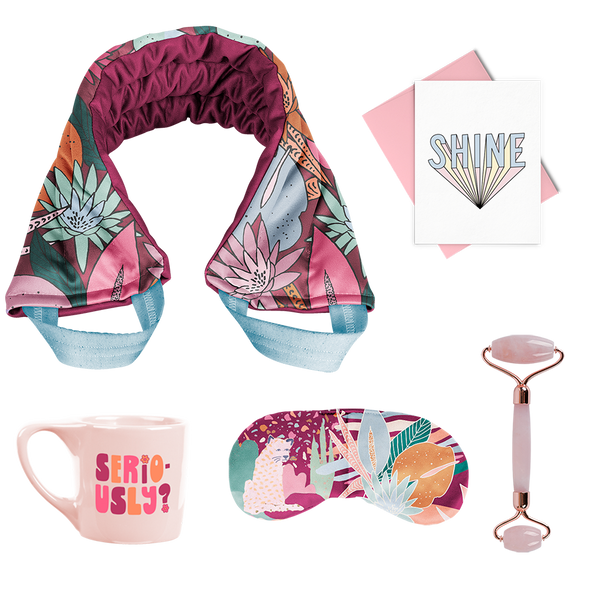 A Floral nights selfie care kit with a pink "Seriously" mug, a "Floral Nights" eye mask, a "Floral Nights" weighted neck wrap, a Rose Quartz face roller, and a greeting card that says "SHINE" in dusty blue letters.