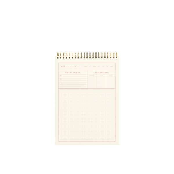 A page in the Zen Ladies Taskpad. Top section had a fillable date section along with days of the week. Two sections below are for "To-do" tasks and for "meals of the day" trackers. The lowest and biggest section is dotted lines. Lining of pages are peach pink colored.