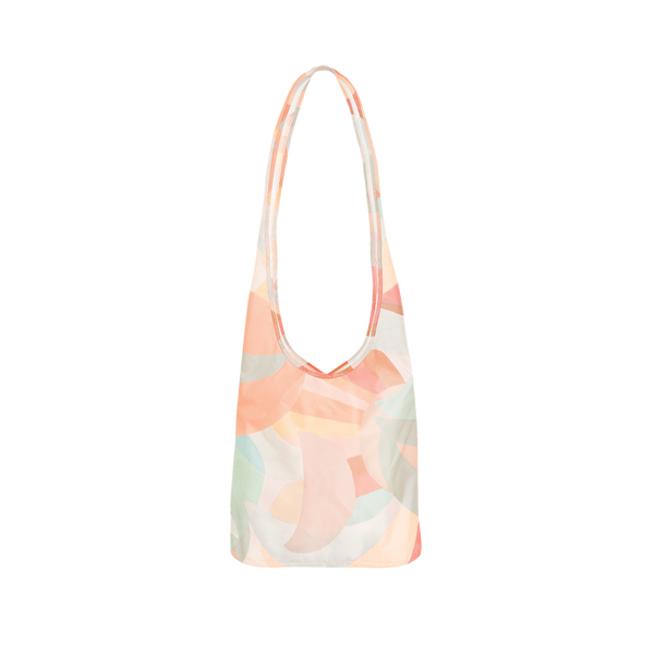 A tote bag with pastel pinks, greens, blues, and reds. Design on bag is multiple moons, overlapping each other.